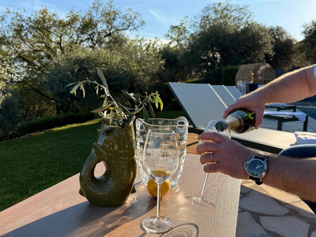Eric verse du champagne sur la terrasse de la Villa Plen Souleù à Cabris, face à l'oliveraie.
